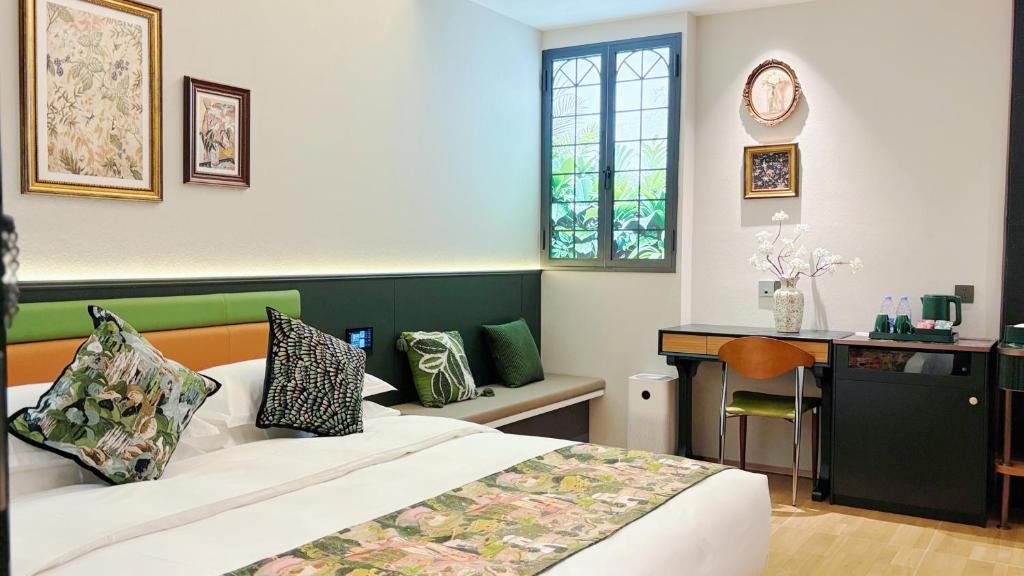 Postel nebo postele na pokoji v ubytování Vishan Garden Boutique Hotel 厦门维尚花园潮宿 中山路步行街店