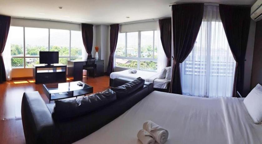 a living room with a bed and a couch at The Living-Hills in Chiang Mai