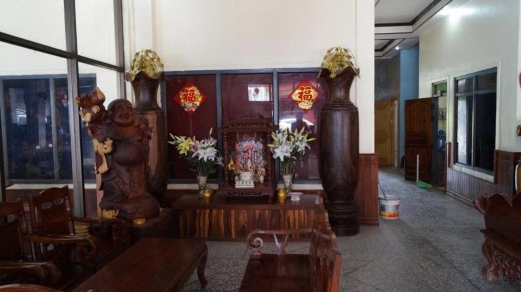 a living room with a table and flowers in it at Lankham Hotel in Pakse
