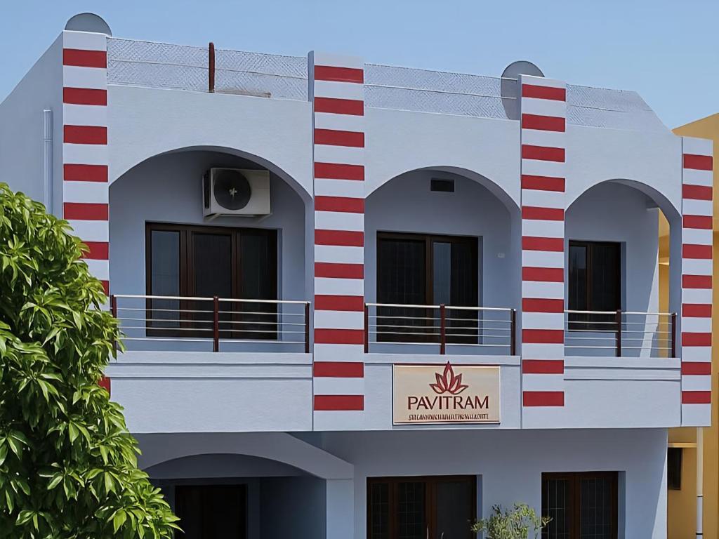 a building with a sign that reads pentium at Pavitram Guest House in Ujjain
