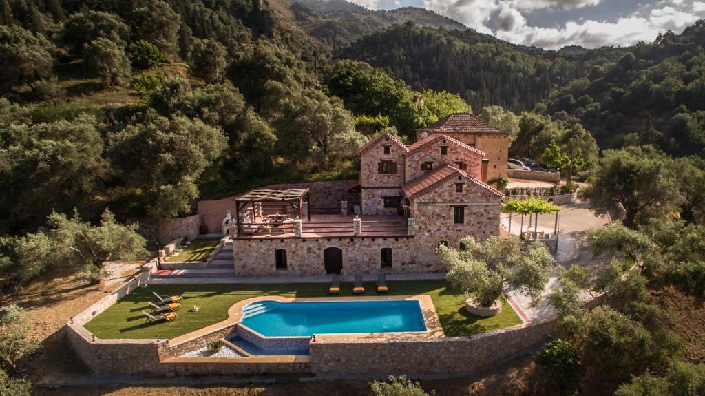 an aerial view of a house with a swimming pool at Villa Fabrica in Thimiá