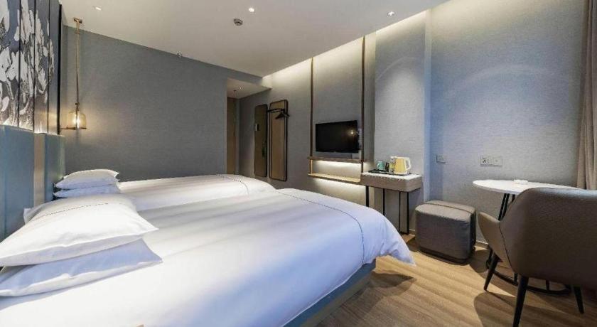 Postel nebo postele na pokoji v ubytování Jinjiang Inn Zhangjiagang Yangshe West Street Pedestrian Street