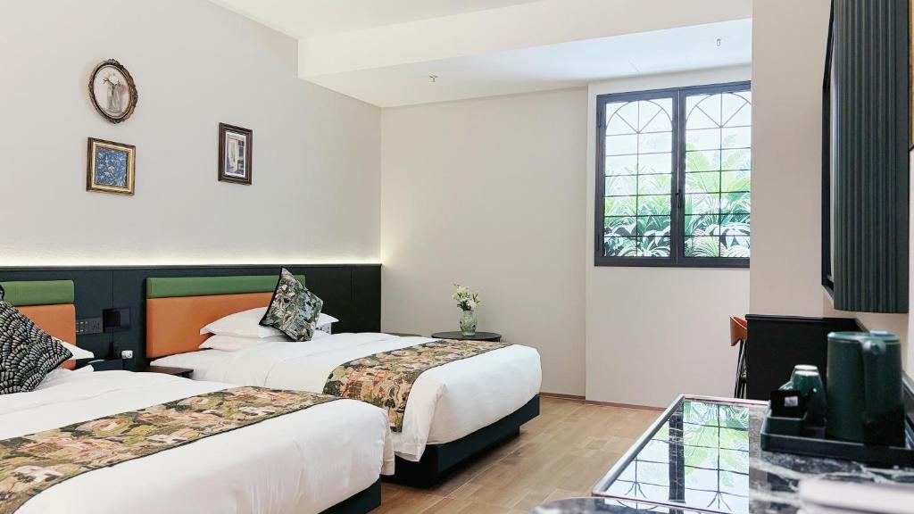 Postel nebo postele na pokoji v ubytování Vishan Garden Boutique Hotel 厦门维尚花园潮宿 中山路步行街店