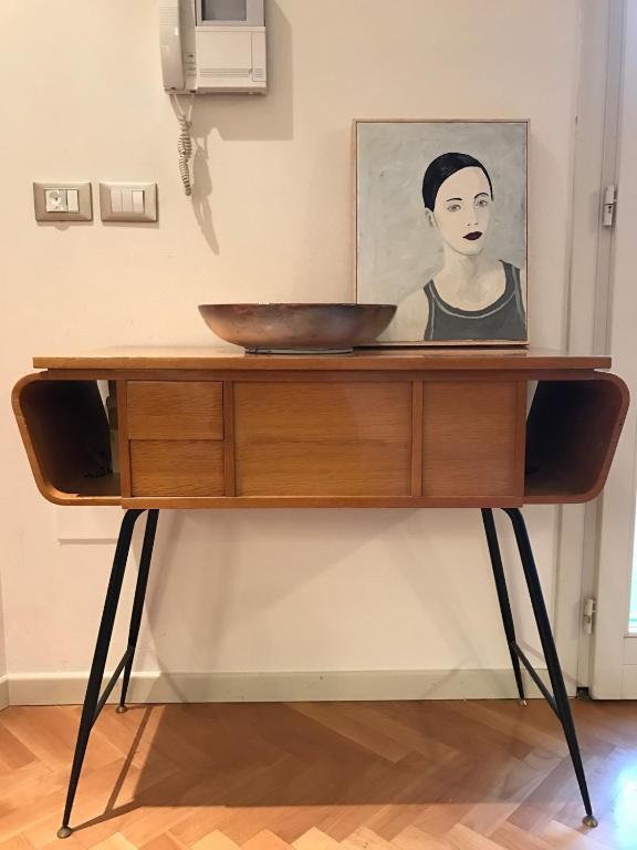 a wooden table with a bowl on top of it at Elegante in centro in Imola