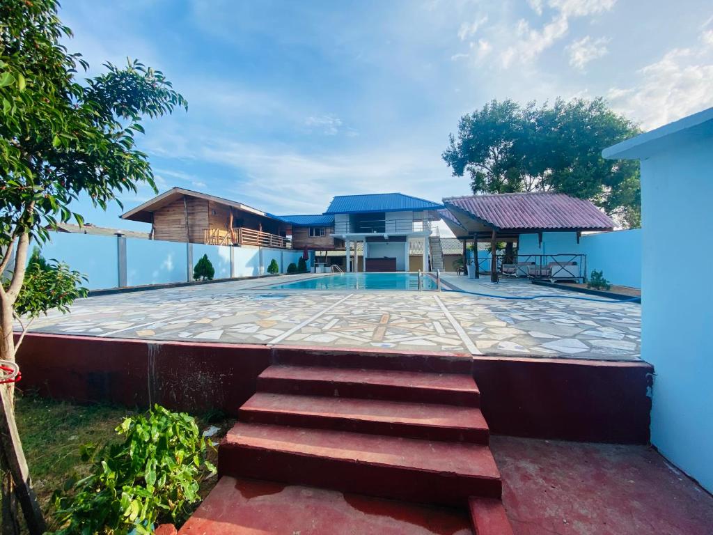 a villa with a swimming pool and a house at MSS Hotel in Trincomalee