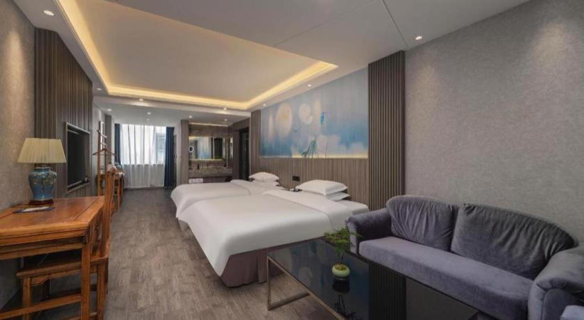 Postel nebo postele na pokoji v ubytování Xi'an Huiya Tianmu Hotel