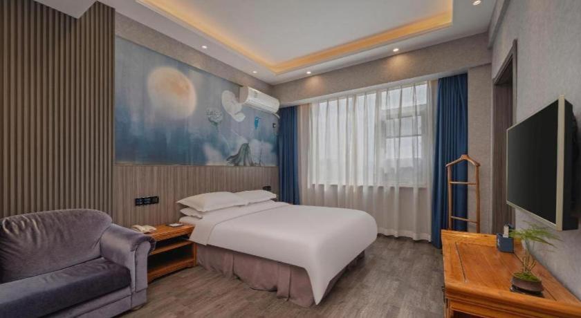 Postel nebo postele na pokoji v ubytování Xi'an Huiya Tianmu Hotel