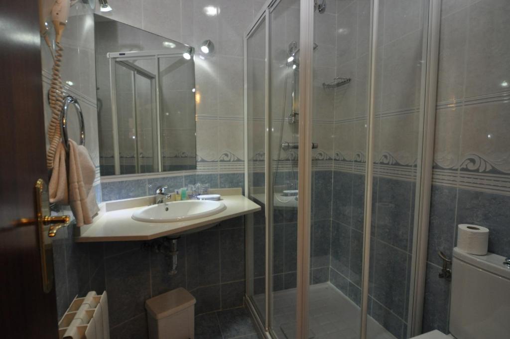 a bathroom with a sink and a shower at Pension Alameda in San Sebastián