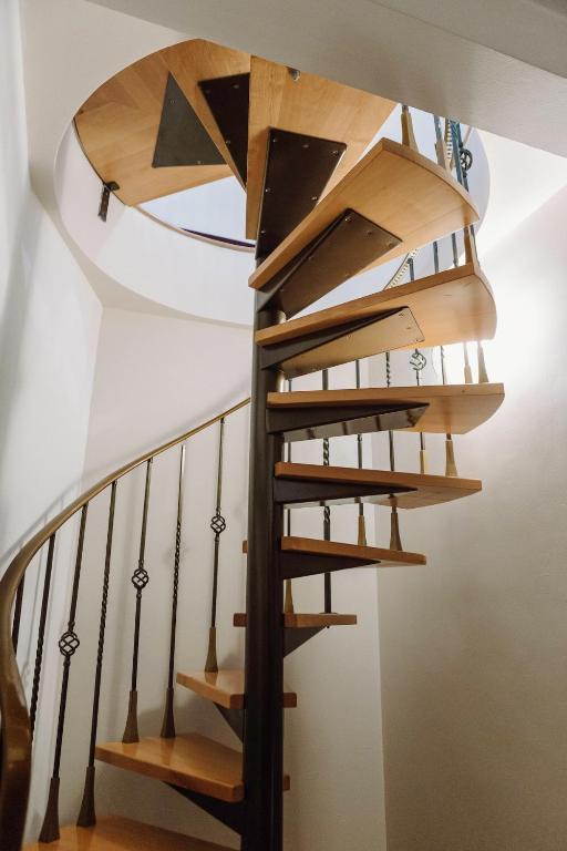 a wooden spiral staircase in a house at Apartment K21 Stare Tychy in Tychy