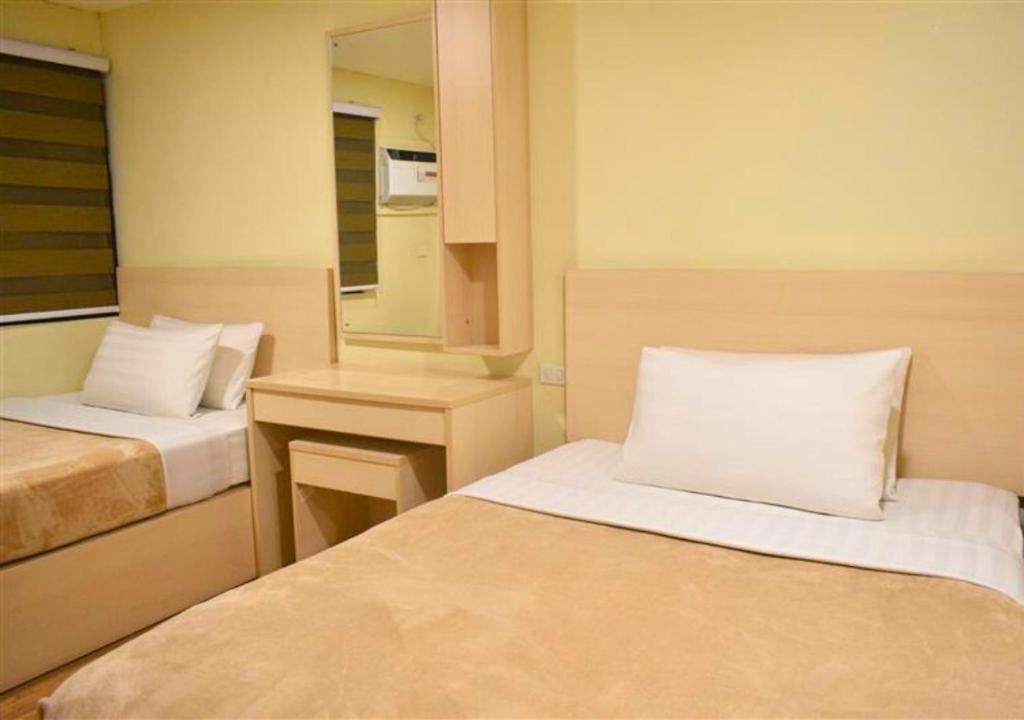 Postel nebo postele na pokoji v ubytování Olive Town Center and Hotel