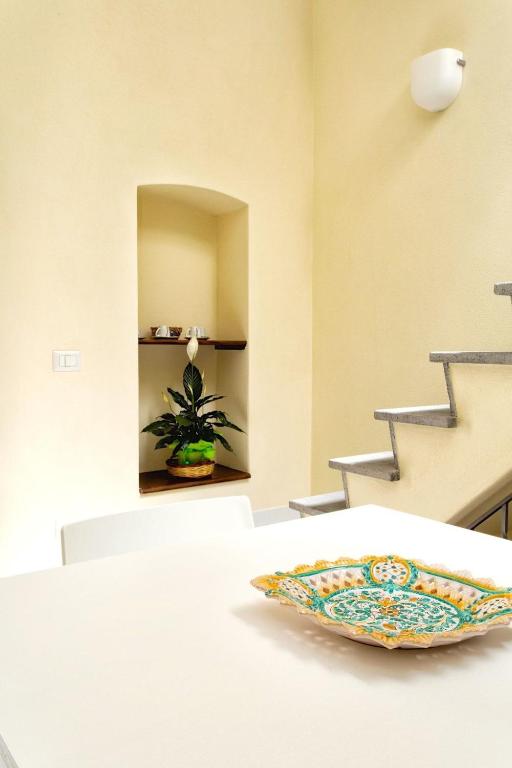 a dining room with a plate on a table at Il Veliero Blu Suite Lipari Centro - Corso Vittorio Emanuele in Lipari