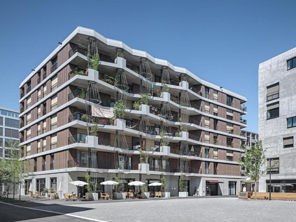 a large apartment building with potted plants on it at Gästehaus Hunziker in Zurich