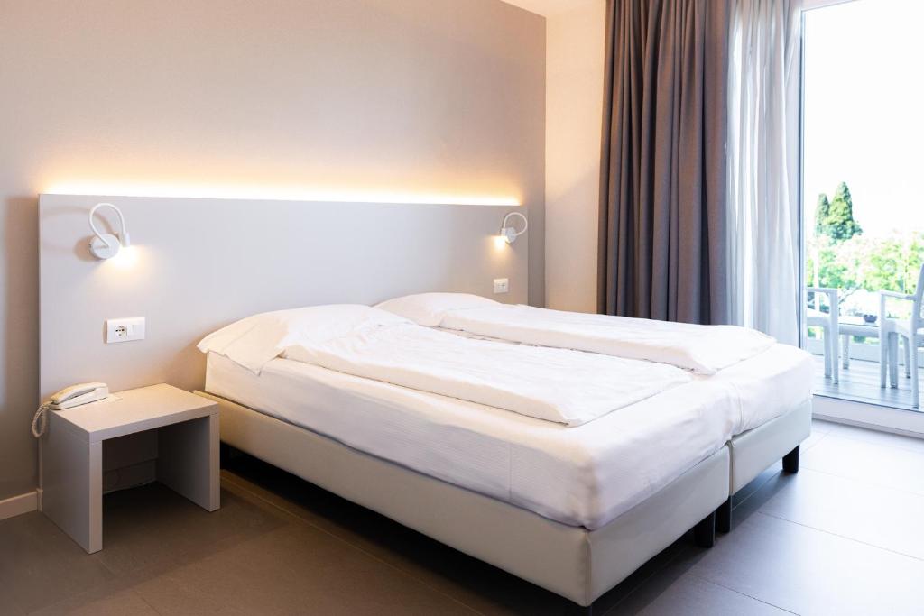 Postel nebo postele na pokoji v ubytování Hotel Paradiso