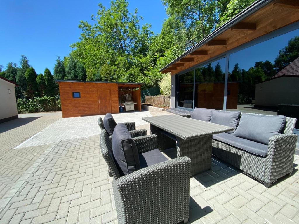 a patio with a table and two chairs and a table and chairs at Villa Tomima in Ostrava