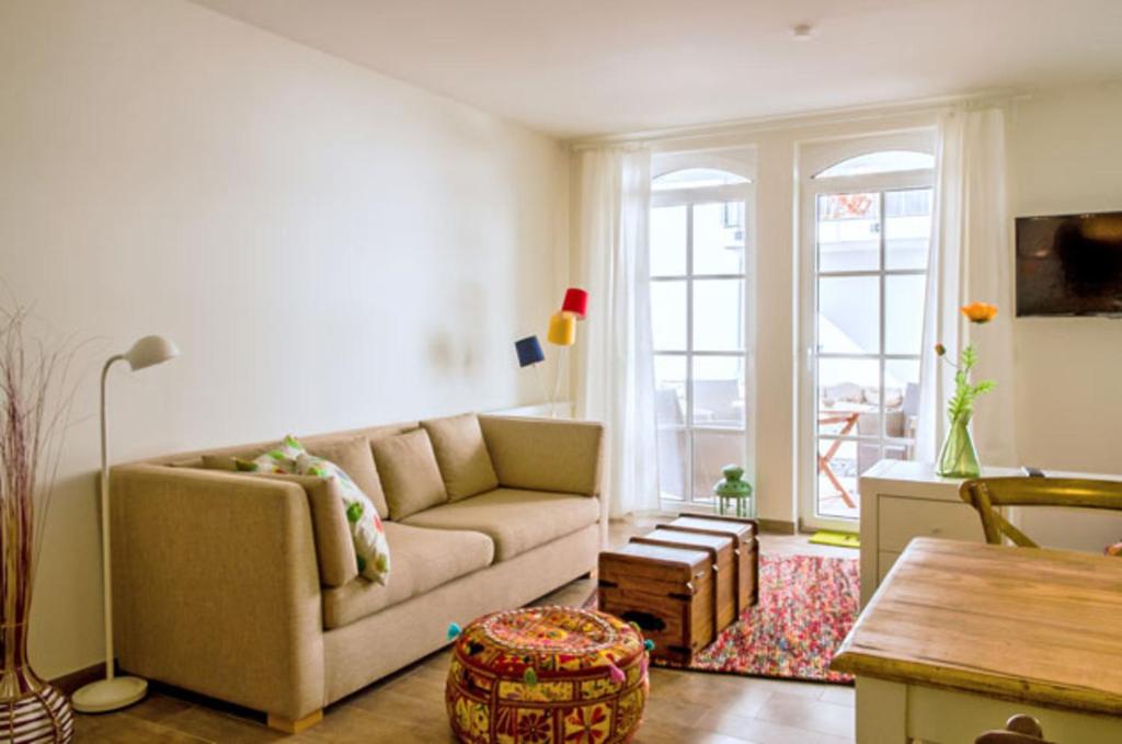 a living room with a couch and a table at Haus Meeresblick - Ferienwohnung Stoertebeker A 0.17 (Ref. 138715 u1) in Baabe