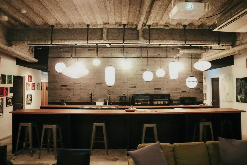 a bar in a room with stools at waves nakameguro in Tokyo