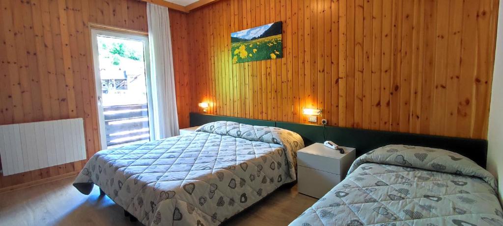 Postel nebo postele na pokoji v ubytování Hotel Miramonti