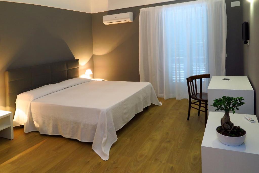 Postel nebo postele na pokoji v ubytování B&B In Centro