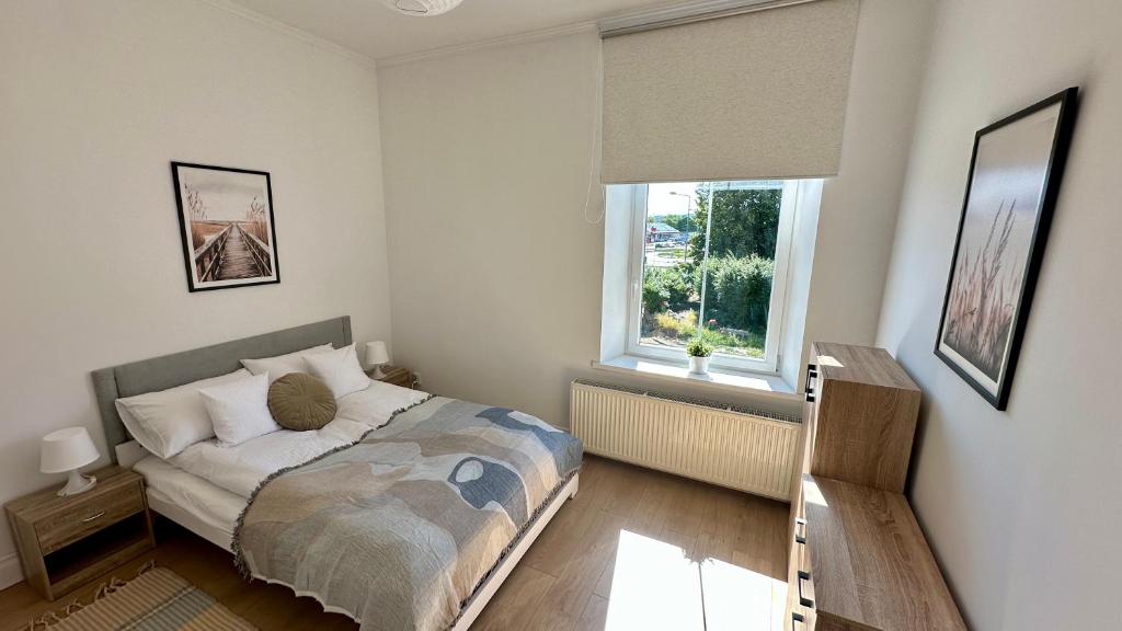 una piccola camera da letto con un letto e una finestra di Przytulny i słoneczny apartament nr 1 Góry Sowie, Jezioro, Centrum a Bielawa