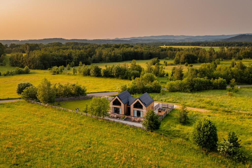 an aerial view of a house in a field at REST ZONE - mountain holiday chalets in Ściegny