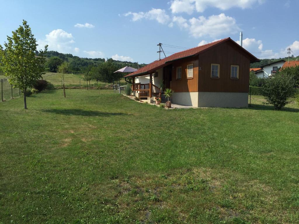 a small house in a field next to a yard at Eisenberg Chalet in Eisenberg an der Pinka