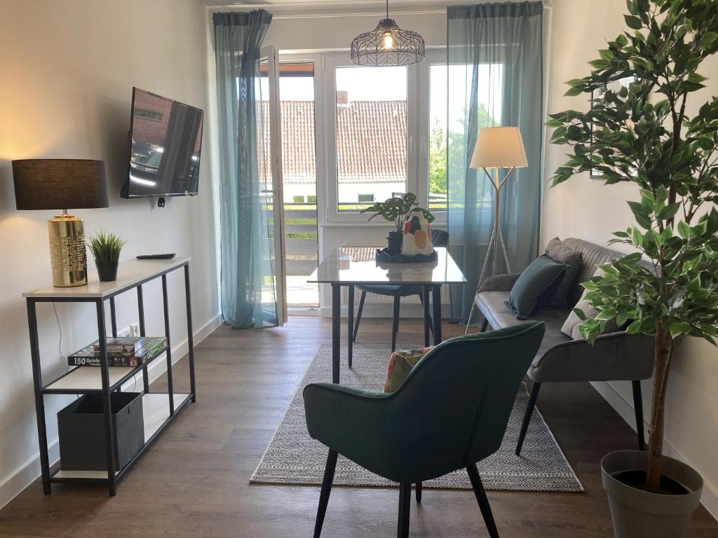 TV a/nebo společenská místnost v ubytování Stranddistel 4