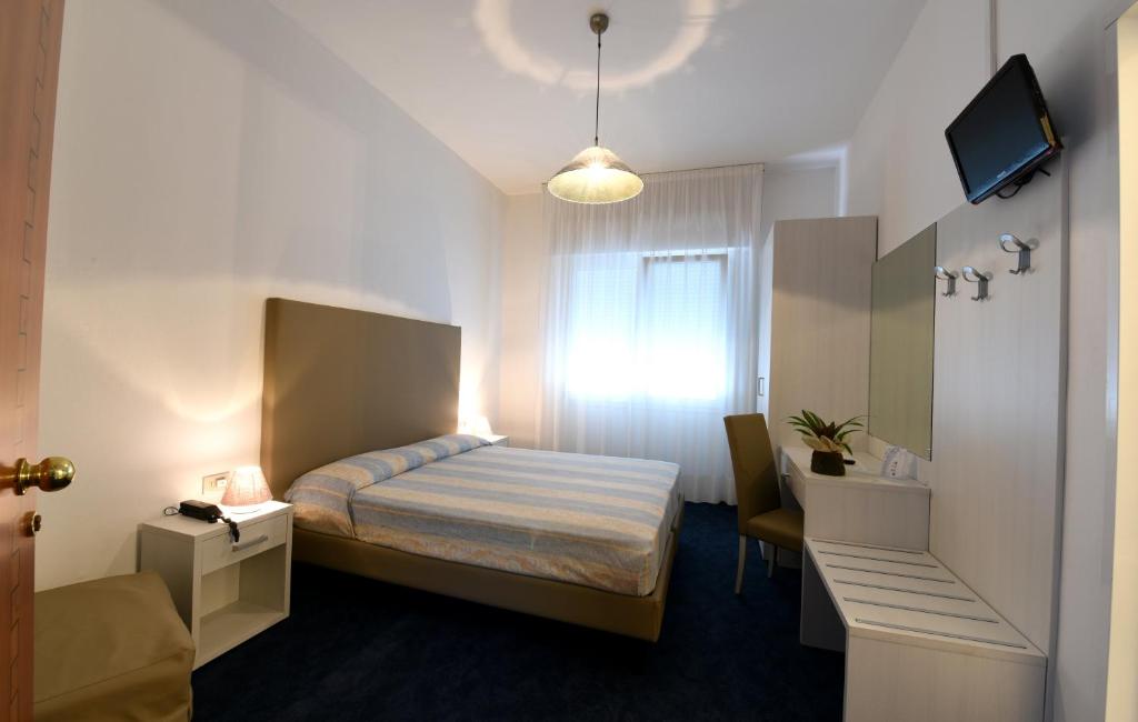 Postel nebo postele na pokoji v ubytování Hotel Savoia