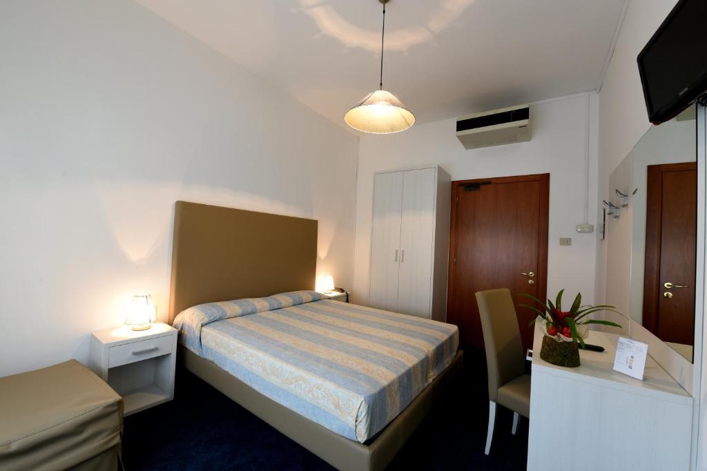 Postel nebo postele na pokoji v ubytování Hotel Savoia