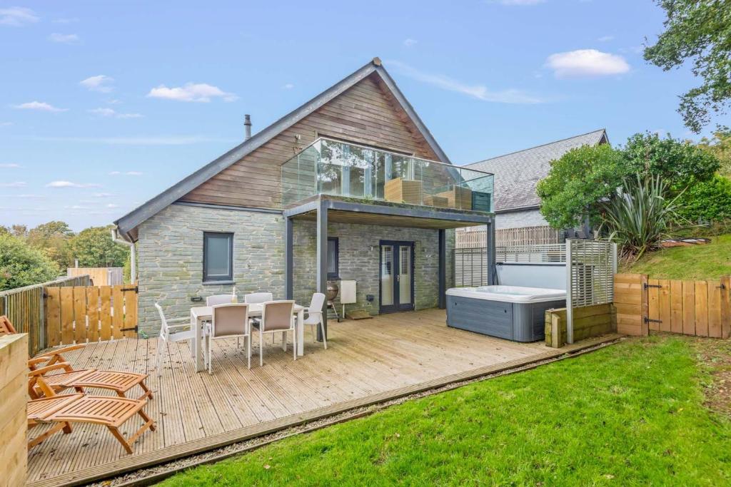 a house with a large deck with a bath tub at House 30 in Looe