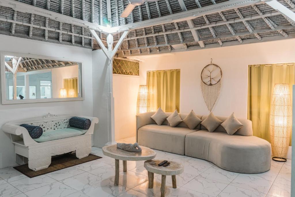 a living room with a couch and a chair at Modern 3BR Villa, 4min to Double Six Beach, Pool in Seminyak