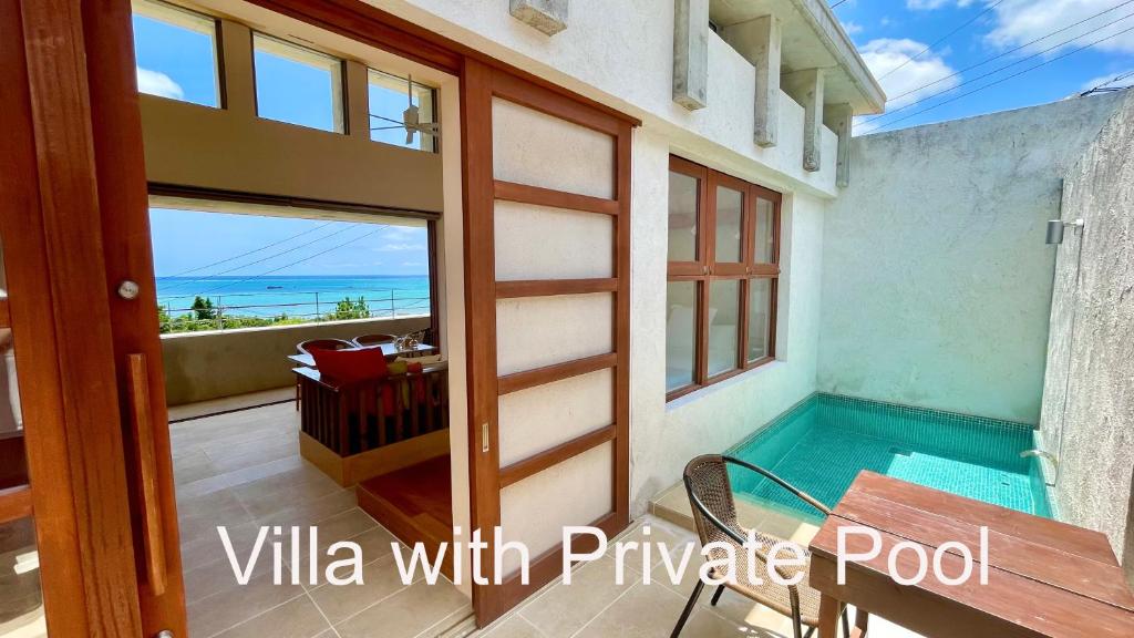 a view of the ocean from the balcony of a villa with private pool at 水と共に過ごすスモールヴィラ　かふーわ知念　 in Chinen