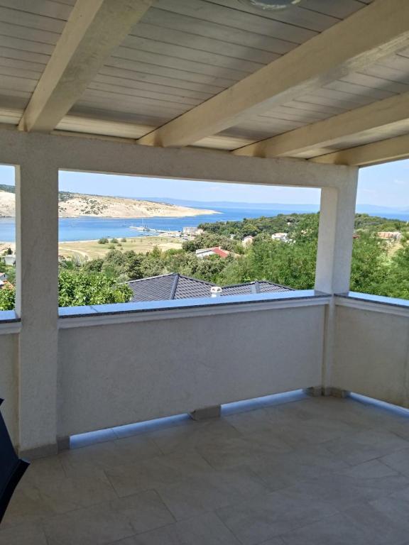a balcony with a view of the ocean at Apartments Zlata in Lopar