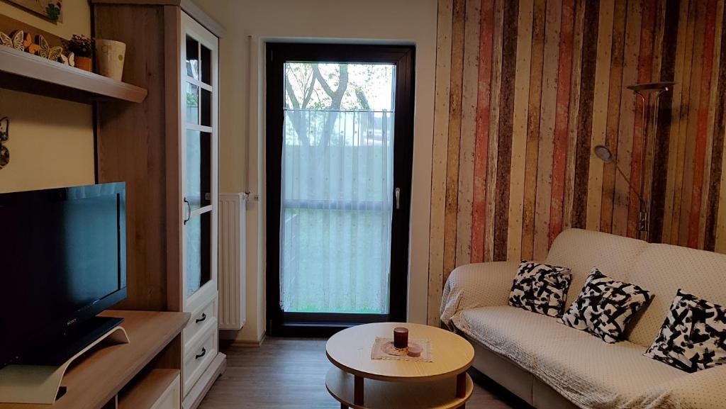 Una sala de estar con un sofá y un televisor. en Ferienwohnung Denninger, 
