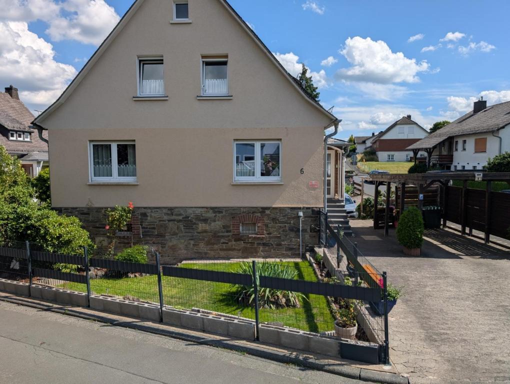 a house with a fence in front of it at Zum alten Schusterhaus in Bad Endbach