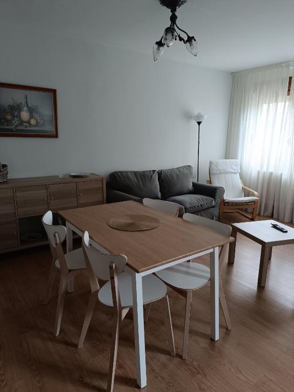 a living room with a wooden table and chairs at Casa Montse-Izquierda in Colombres