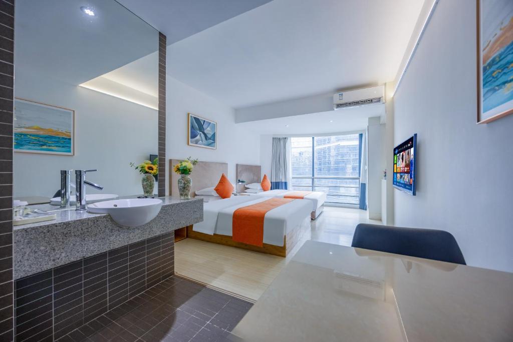 a hotel room with a bed and a sink at Guangzhou Timmy Hotel in Guangzhou