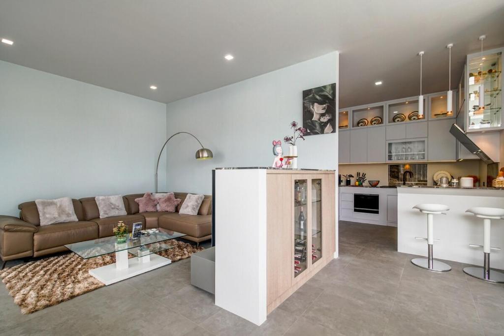 a living room with a couch and a kitchen at Fin Villa Bang Saray in Bang Sare
