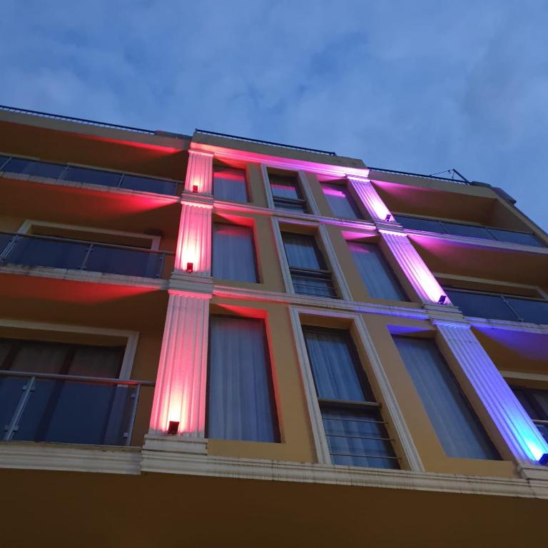 a building with colorful lights on the side of it at Batomi hotel in Batumi
