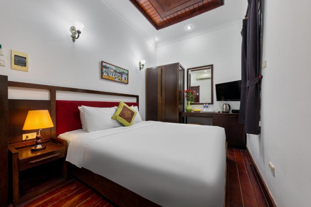 Postel nebo postele na pokoji v ubytování Hanoi Posh Boutique Hotel