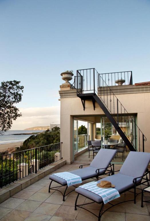 a house with a balcony with a view of the ocean at Tremezzo Villa in Plettenberg Bay