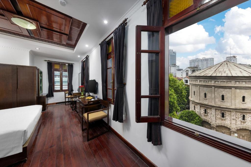 Postel nebo postele na pokoji v ubytování Hanoi Posh Boutique Hotel