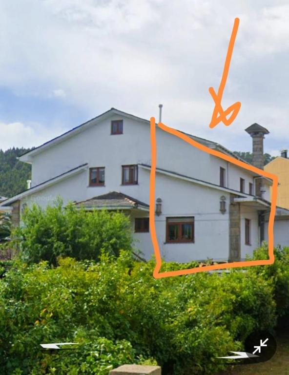 a house with an orange ribbon in front of it at Covas Beach Ocean in Lago