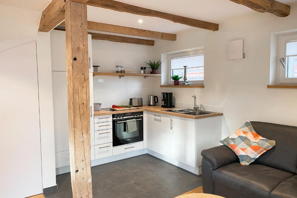 a living room with a couch and a kitchen at Ferienwohnung Alter Stall - rechte Seite für 3 Personen in Ohne