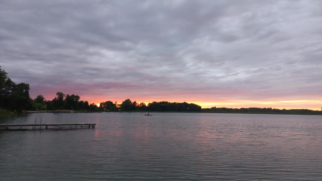 a view of a lake with a boat in the water at Pokój u Julii in Okuninka