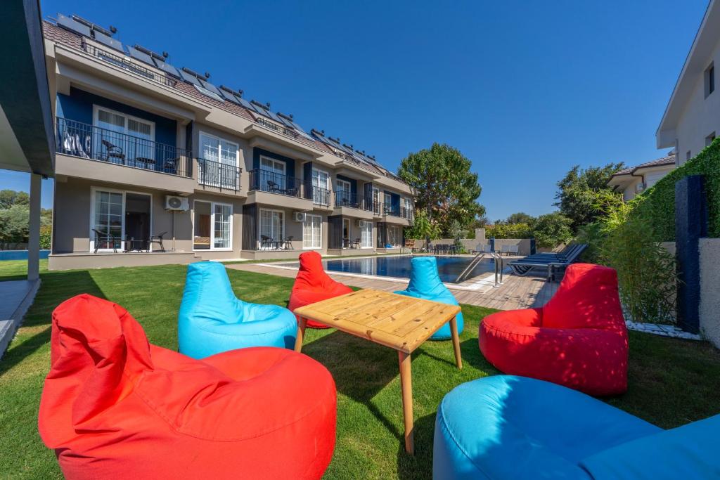 a group of chairs and a table in front of a building at Dede Suites Fethiye in Fethiye