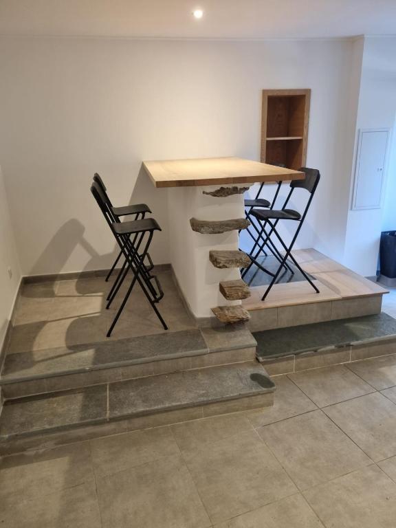 a table and two chairs sitting on a stone floor at Maison Samuela in Grillasca