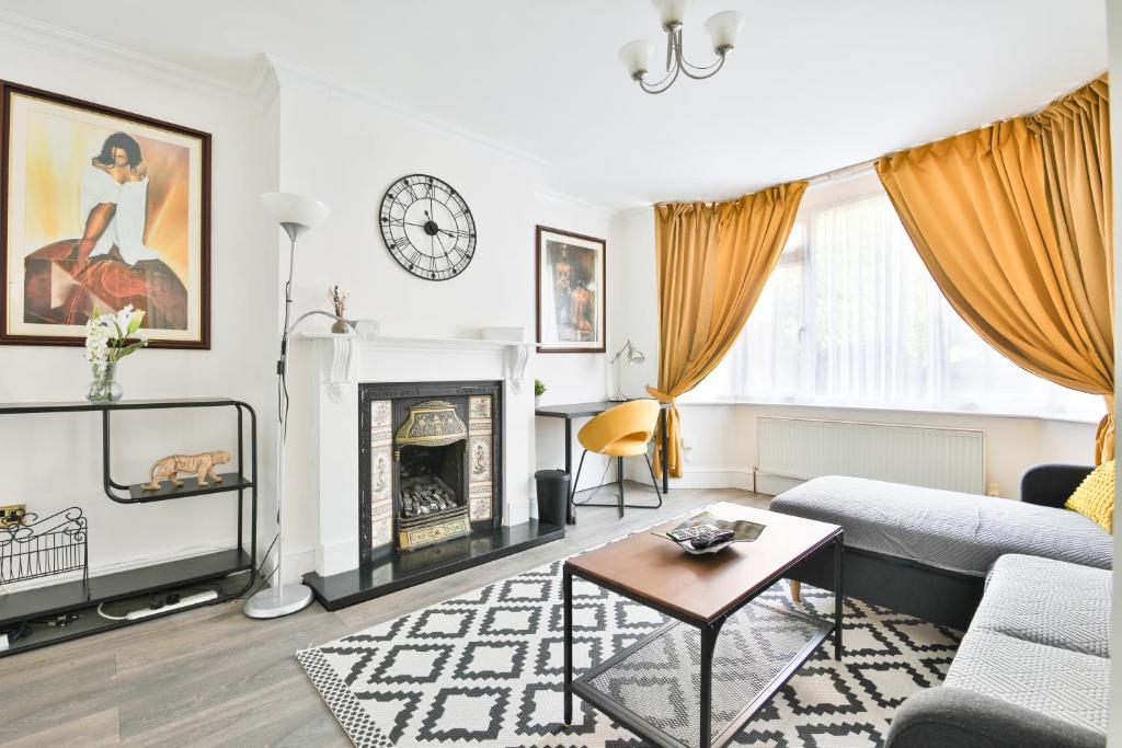 a living room with a couch and a fireplace at The Wishing Well- Lovely Spacious Home In BS4 Sleeps 8 By STAE- Homes in Bristol