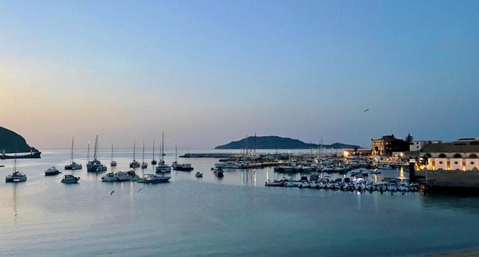 a group of boats are docked in a harbor at Casa Praia in Favignana