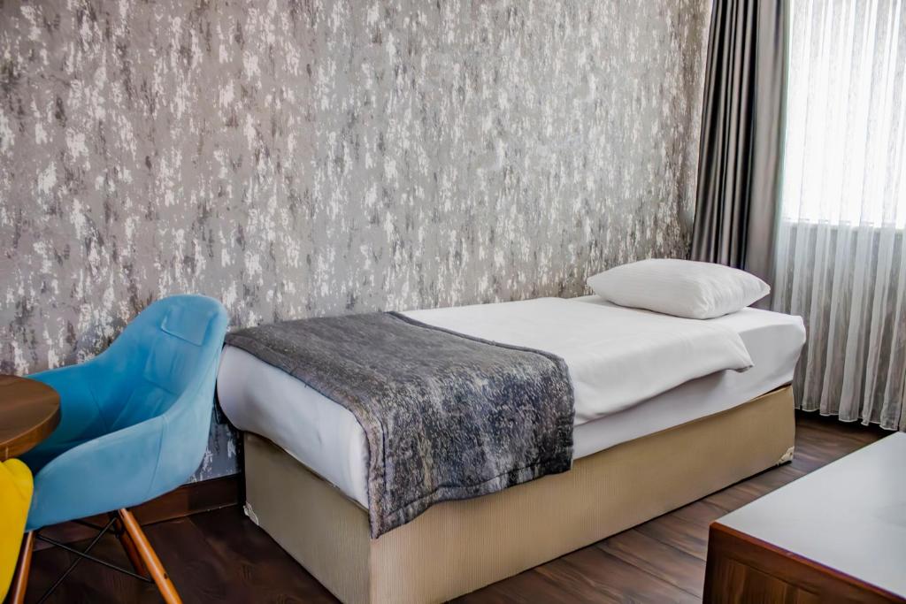 Postel nebo postele na pokoji v ubytování Ma City Hotel