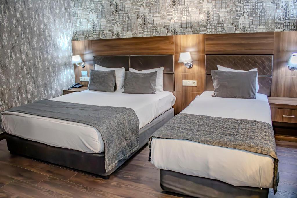 Postel nebo postele na pokoji v ubytování Ma City Hotel